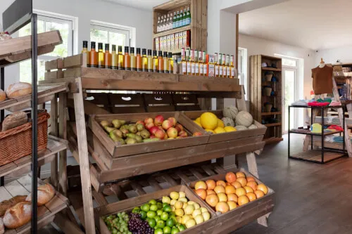 Fresh fruits and beverages displayed in a wooden market stand at Roxburghe Hotel Golf & Spa Ltd.