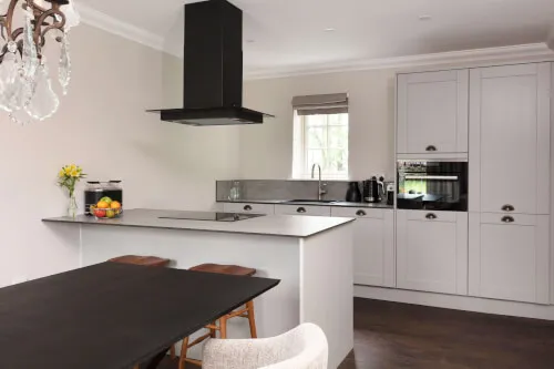 Modern kitchen with minimalist design, featuring a sleek island and stylish appliances.