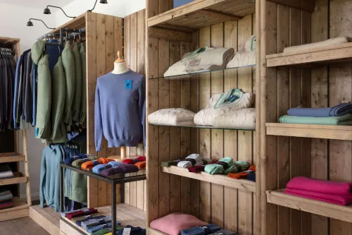 Cozy retail space with a variety of sweaters and colorful accessories for stylish outfits.