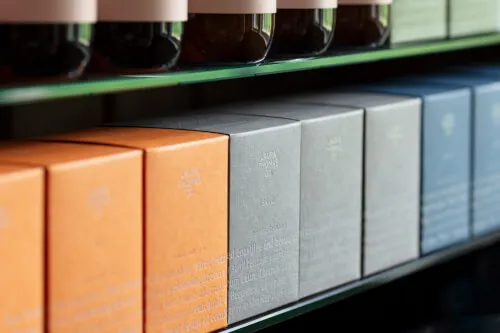 Colorful boxes of luxury spa products displayed on a shelf.